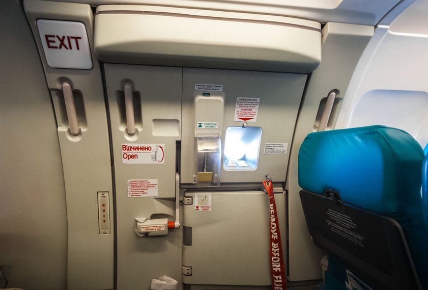 34015251 - closeup shot of emergency exit door in airplane