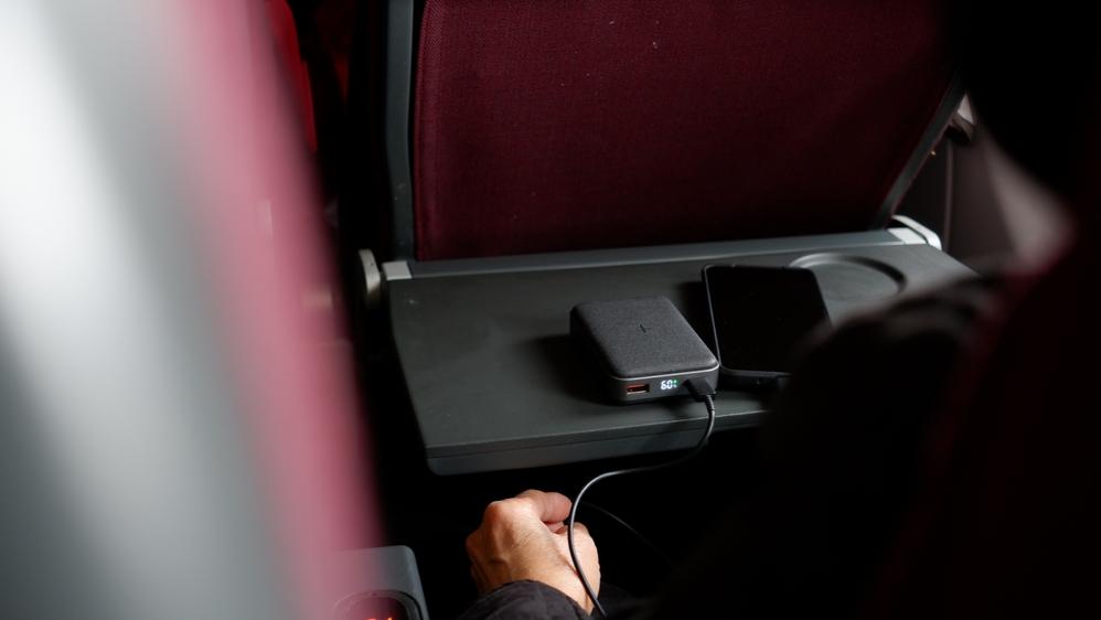 Mobile charger on a flight. Photo: wisely / Shutterstock