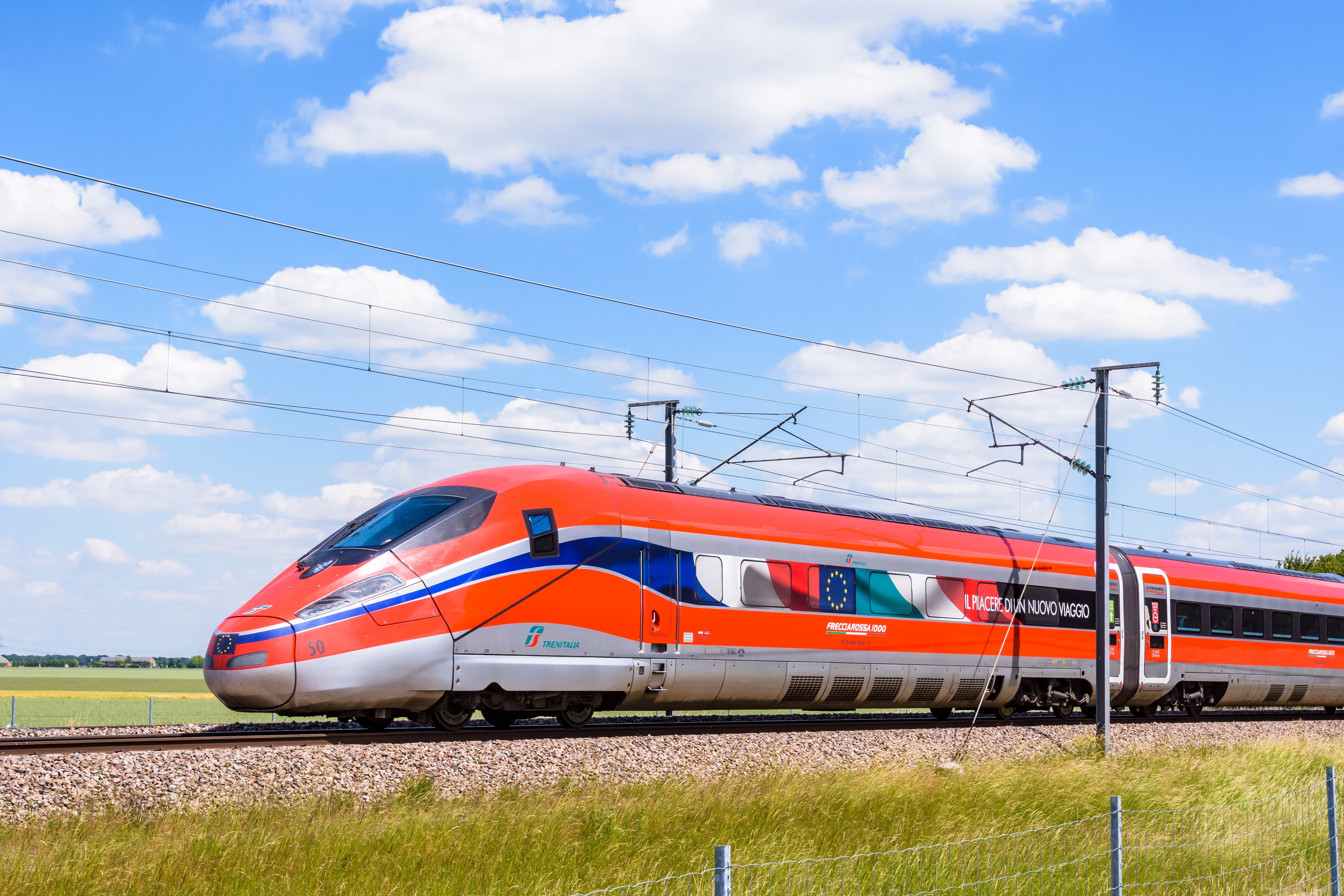 A Frecciarossa (ETR 1000) high speed train from italian rail company Trenitalia is driving from Lyon to Paris. Photo: olrat / Shutterstock