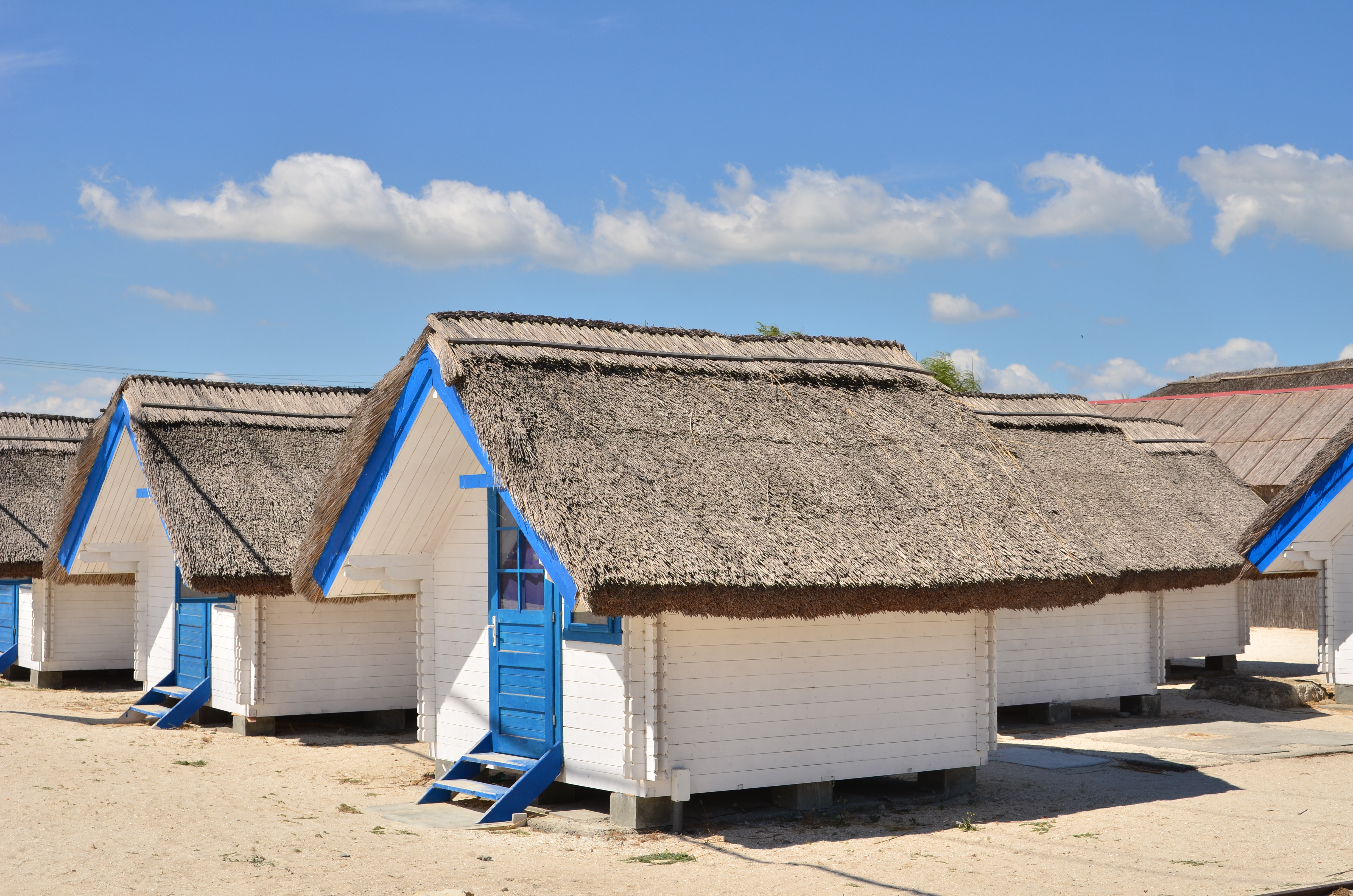 Wooden beach huts with thatched roofs at Gura Portitei. Photo: Shutterstock